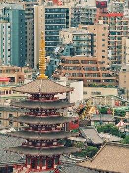 Urban landscape of Tokyo with a traditional pagoda amidst modern buildings.