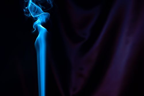 Free A captivating abstract art piece featuring ethereal blue smoke on a dark background, exuding elegance and mystery. Stock Photo