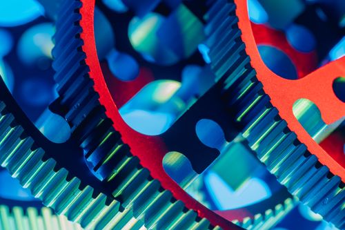 Free Vibrant close-up of mechanical gears in red and blue lighting, showcasing industrial precision. Stock Photo