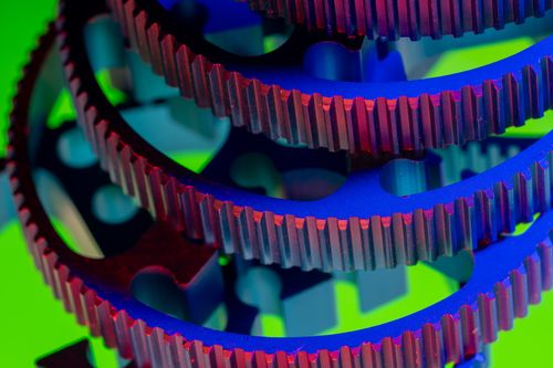 Free Vibrant close-up of interlocking colorful gears showcasing industrial precision and engineering. Stock Photo