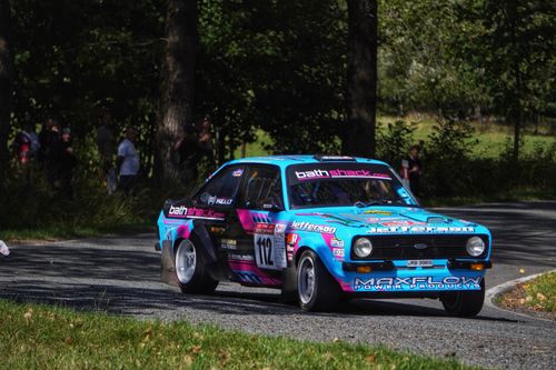 Free Dynamic rally car racing in a forest setting, showcasing vintage vehicle power and speed. Stock Photo