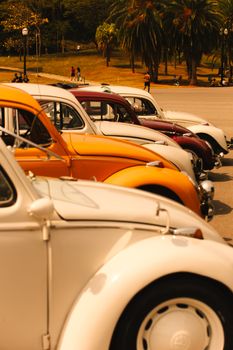 Classic Volkswagen Beetles parked in São Paulo, Brazil, showcasing vibrant colors.