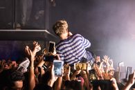 Anonymous singer surfing crowd during show
