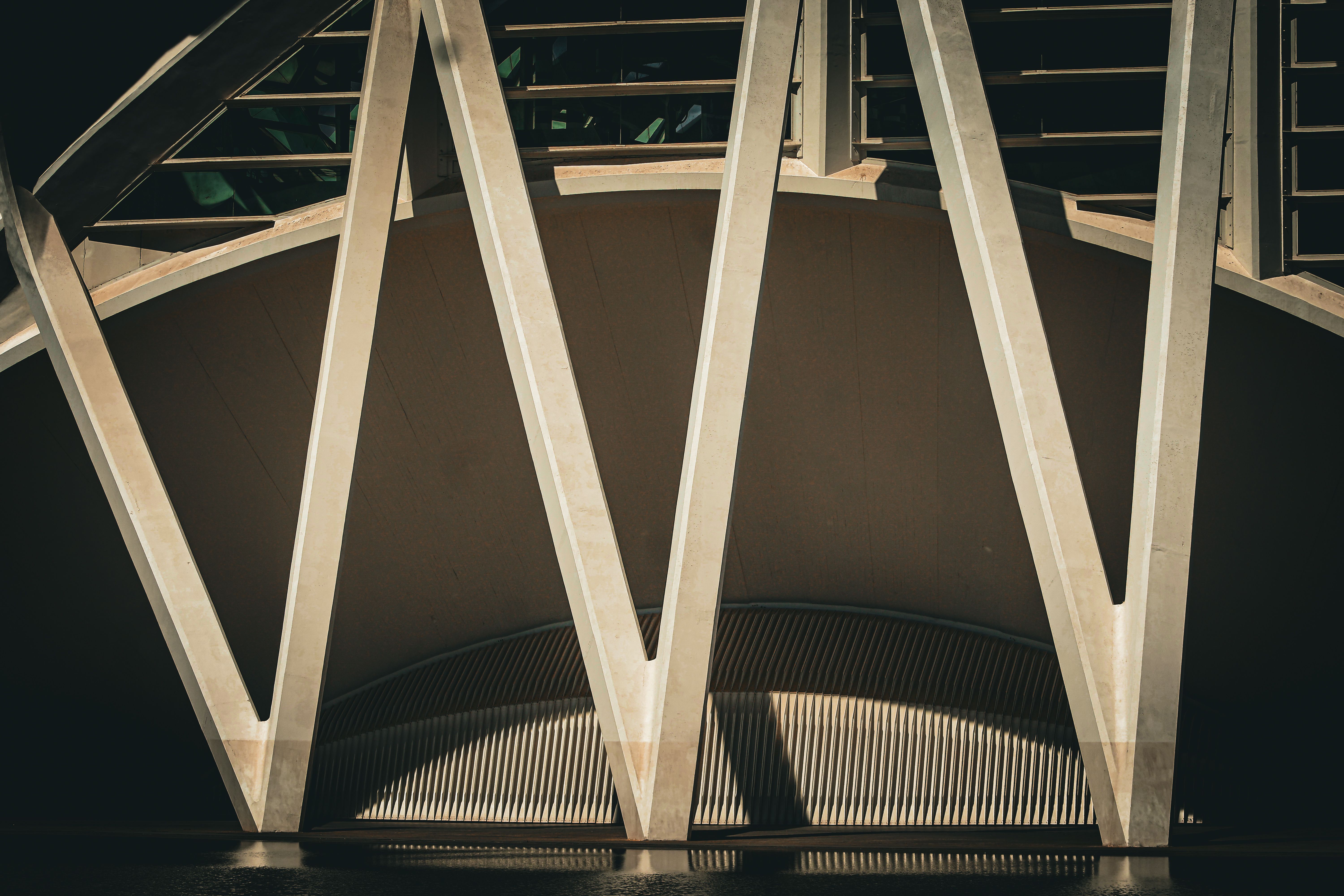 Abstract photo showcasing the geometric design of a modern architectural structure with strong shadow patterns.
