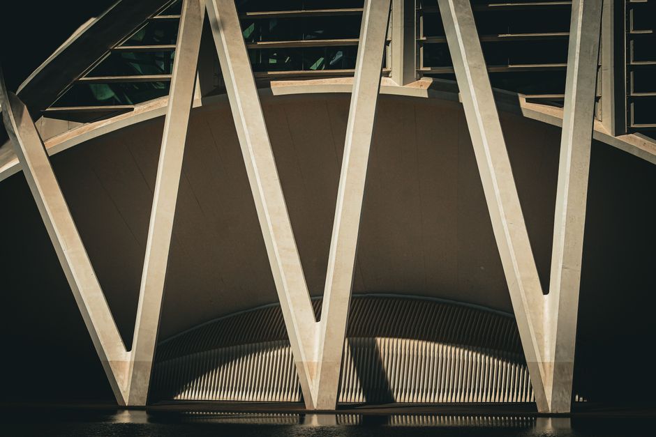 Abstract photo showcasing the geometric design of a modern architectural structure with strong shadow patterns.