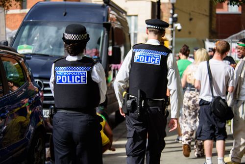 Free Two Metropolitan Police officers on patrol during a city event in daylight. Stock Photo