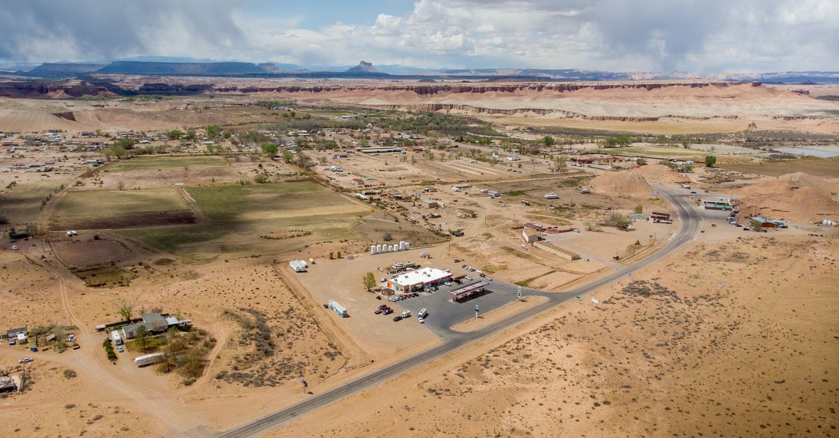 Scenic aerial view of Hanksville, Utah showcasing a small desert town with expansive landscapes and roads.