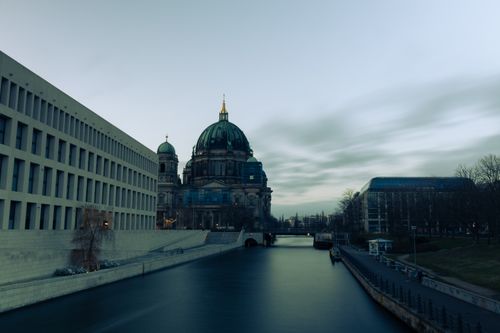 Free Scenic view of Berlin Cathedral and museum buildings at twilight, reflected in the Spree River, Berlin, Germany. Stock Photo