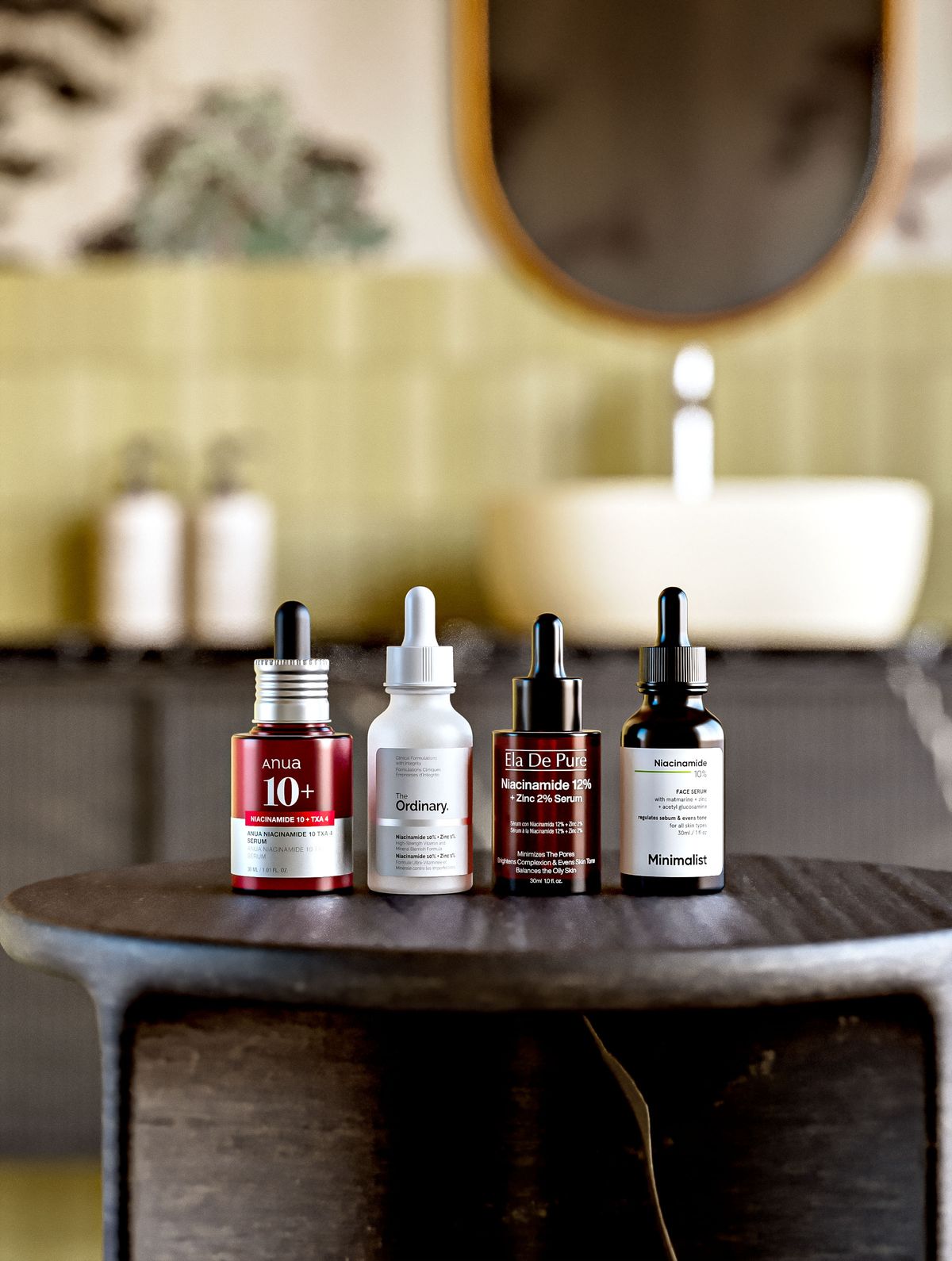 Four serum bottles on a dark wooden stool by a basin