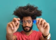 Man In Red Crew Neck Shirt Holding Eyeglasses