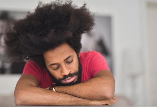 Free A serene portrait of an African American man resting with eyes closed, embracing tranquility. Stock Photo