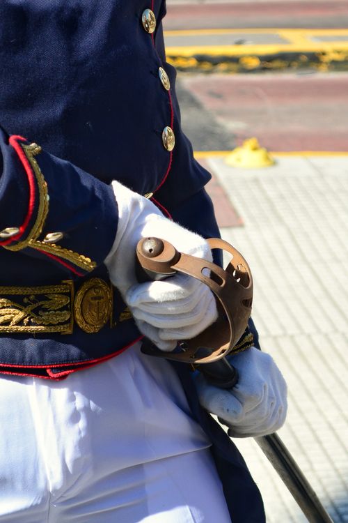 Free A detailed view of a ceremonial uniform and sword, highlighting intricate design and craftsmanship. Stock Photo