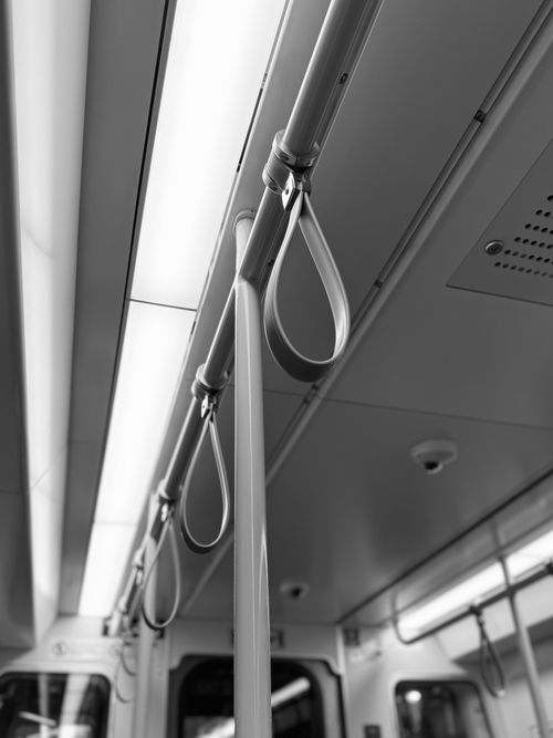 Free Black and white view of subway handles and ceiling lights creating a minimalist effect. Stock Photo
