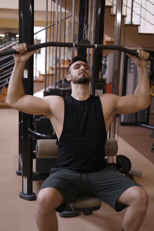 Man In Black Tank Top Working Out