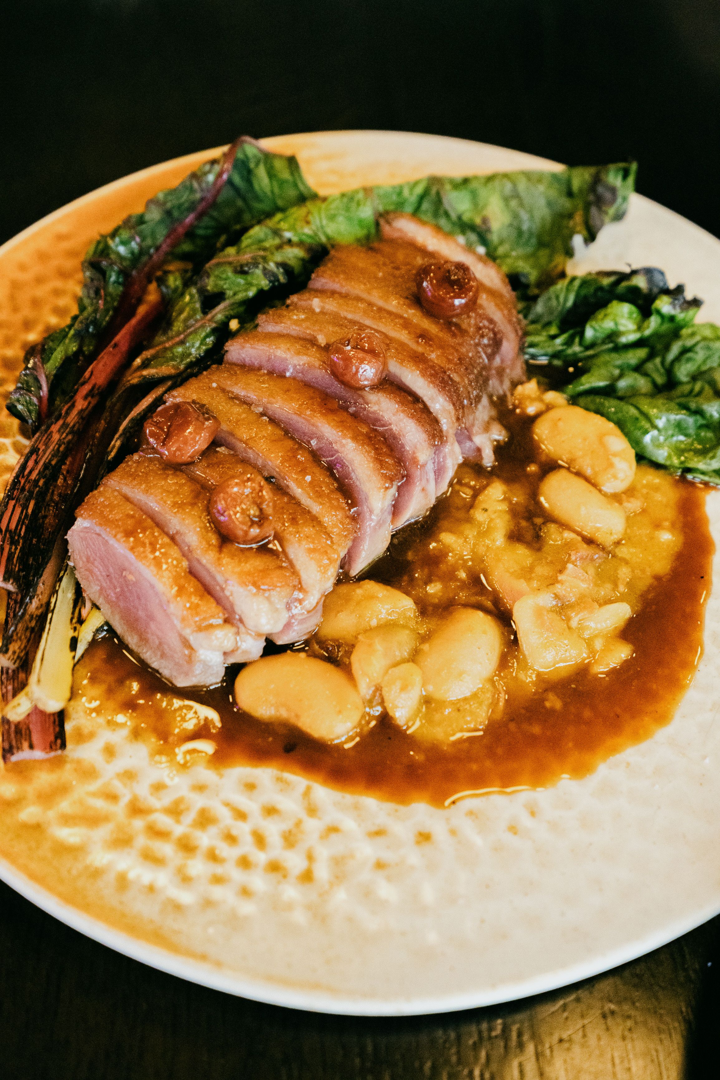 Crisp-skinned duck breast seared low and slow starting in a cold pan, rendering the fat before a quick final sear.