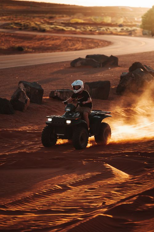 Free Riding an ATV through the Arizona desert at sunset, capturing the thrill and warm vibes. Stock Photo