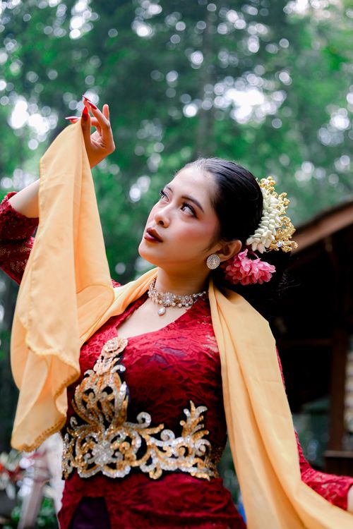 Free A woman poses in traditional dance attire, showcasing cultural heritage outdoors. Stock Photo