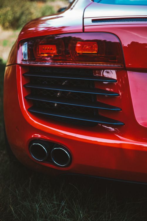 Free Detailed close-up of a luxury red sports car rear, showcasing taillights and exhausts in Dublin. Stock Photo