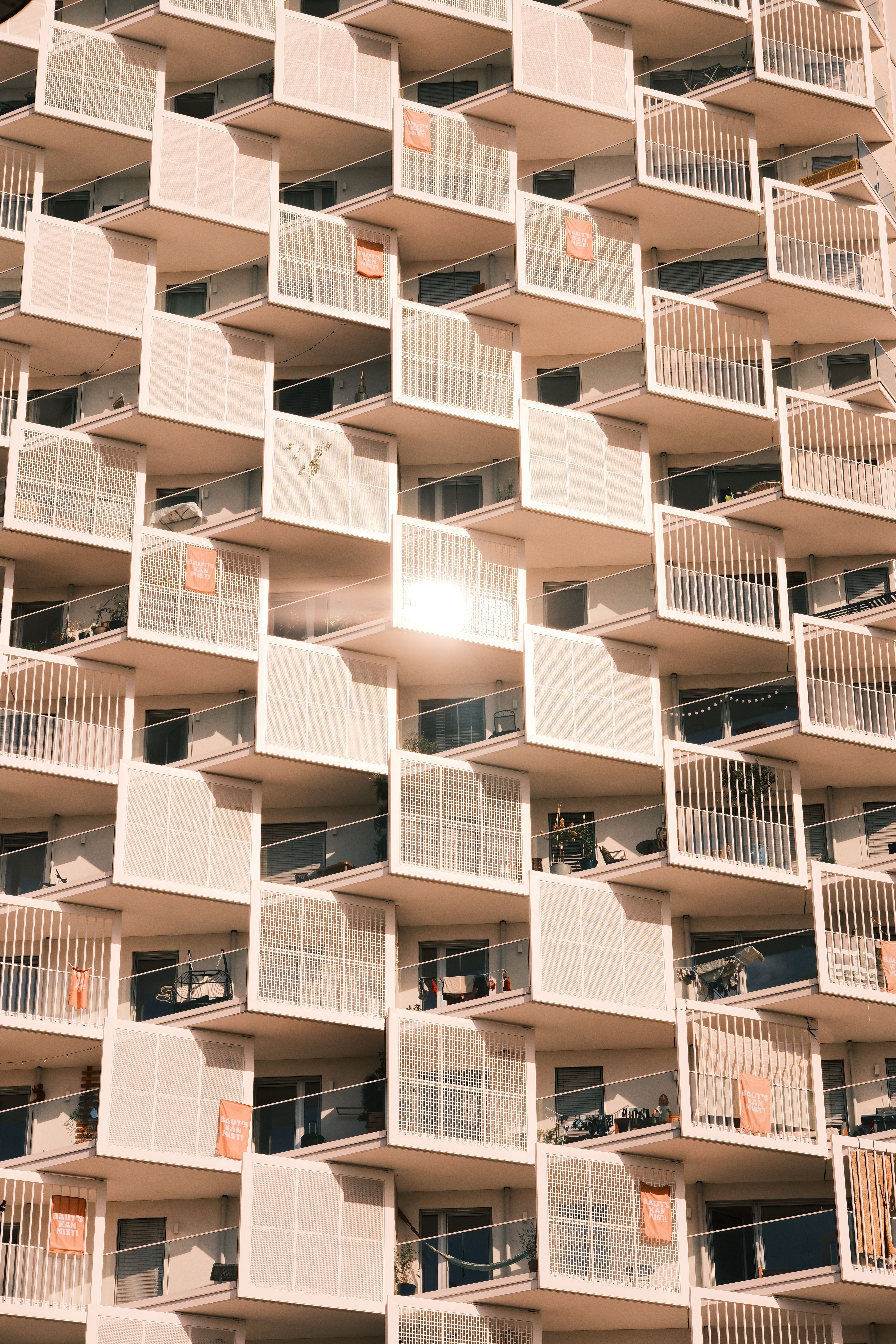 Iconic Vienna architecture featuring a grid of balconies in warm sunlight.