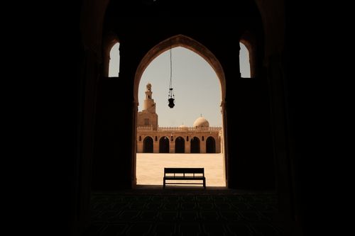 Free Silhouette of mosque archway with view of courtyard and dome in Cairo, Egypt. Stock Photo