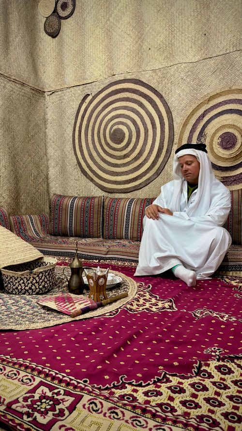 Free A man in traditional attire enjoys tea inside a traditional Emirati setting in Fujairah, UAE. Stock Photo