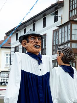 Traditional giant puppets at a street festival in Comillas, Cantabria, Spain. Festive and cultural atmosphere.