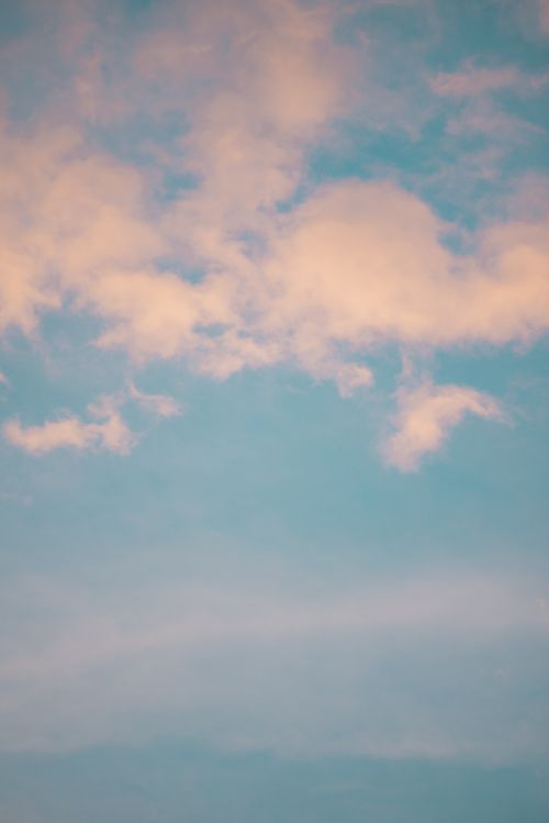 Free Gentle pastel-toned sky filled with soft pink clouds on a clear day. Stock Photo