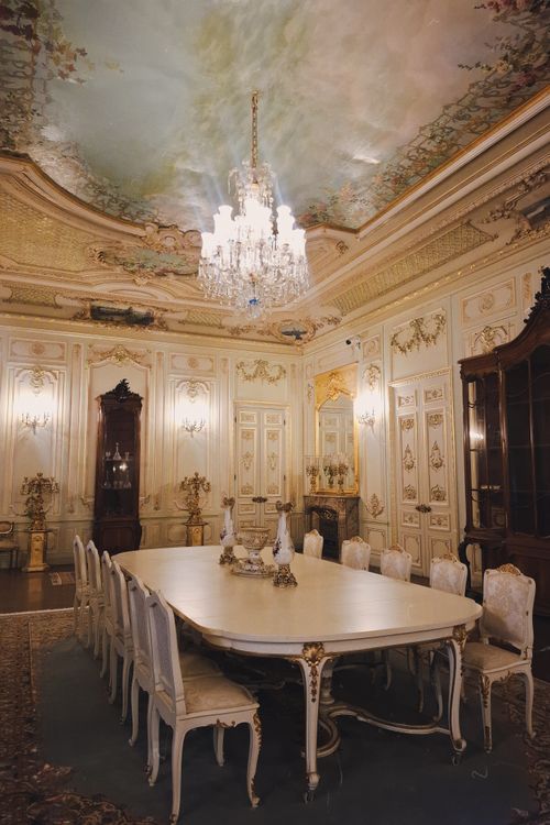 Free Luxurious dining room with intricate ceiling frescoes and elegant chandelier in an İstanbul mansion. Stock Photo