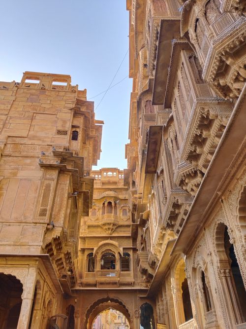 Free Detailed stone carvings and historic architecture of traditional Indian havelis under a clear sky. Stock Photo