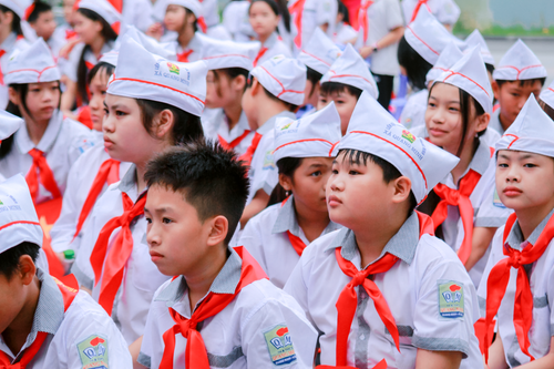 Free Group of children dressed in uniforms attending a school event outdoors. Stock Photo