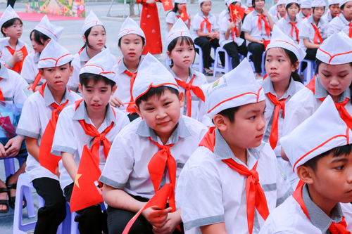 Free Group of Vietnamese students in uniform during a school ceremony outdoors. Stock Photo