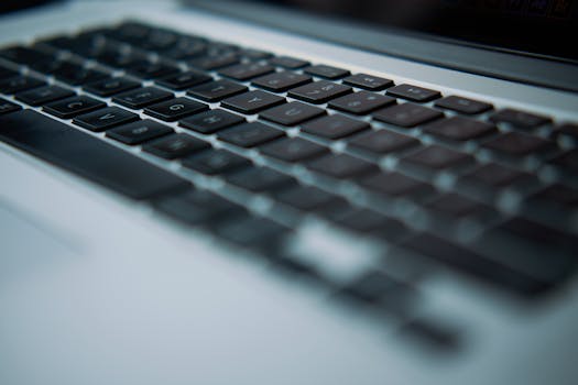 Detailed close-up of a sleek laptop keyboard with shallow depth of field.