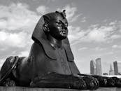 Sphinx statue near modern city