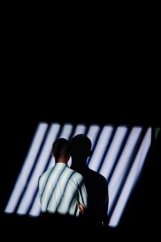 A solitary figure in a dramatic play of light and shadow, captured in Rwanda.