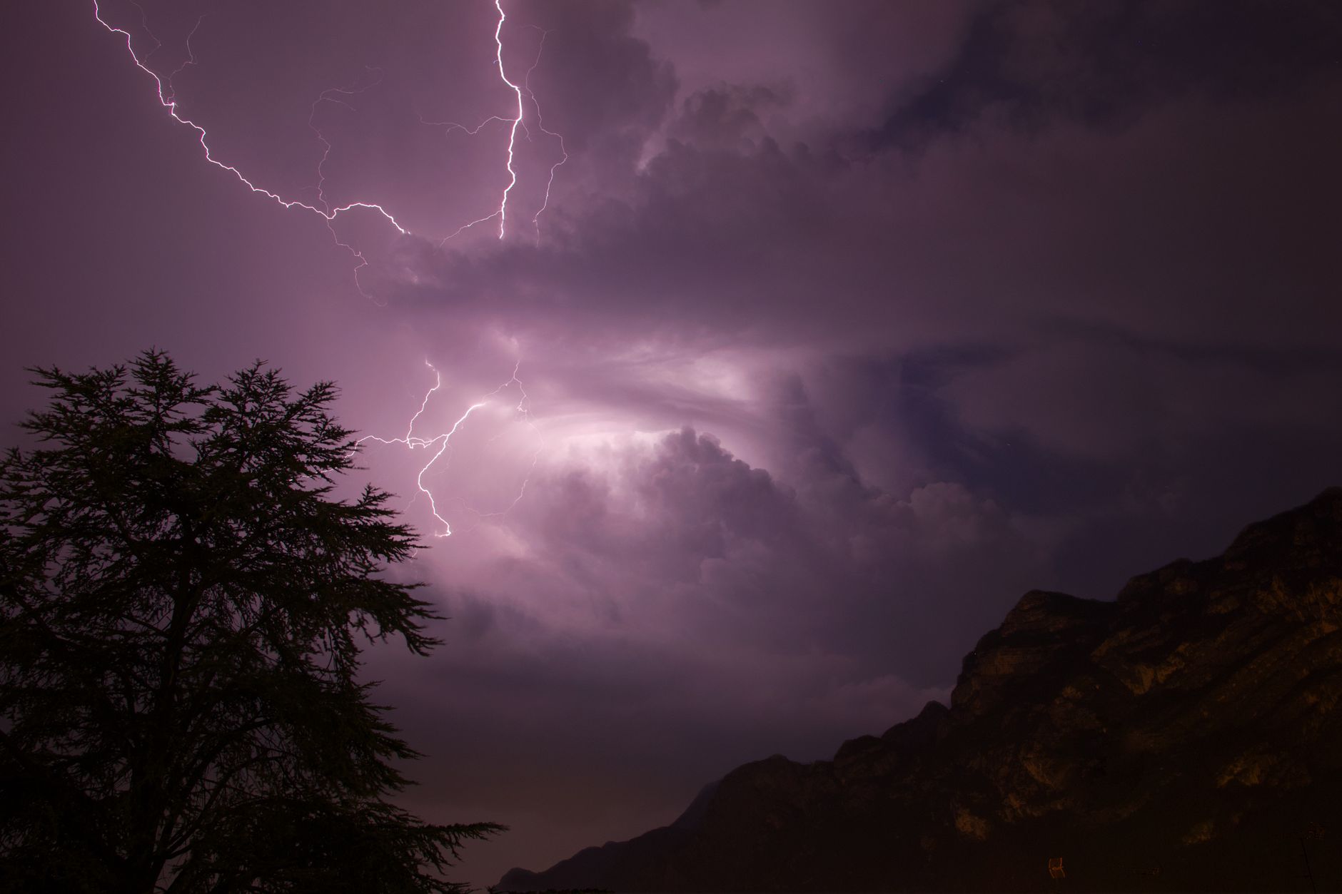 Stunning night shot of a lightning storm over mountains in Italy.