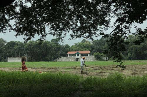 Free Local farmers tending to fields in lush green surroundings near Raipur, India. Stock Photo