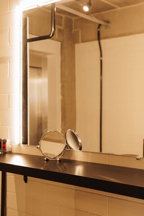 Free Stylish dressing table in a studio with an illuminated mirror and sleek design. Stock Photo