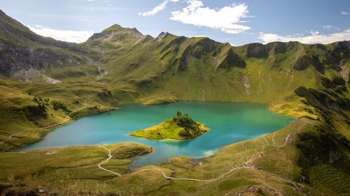 Free Beautiful turquoise alpine lake surrounded by lush green mountains in Bad Hindelang, Germany. Stock Photo