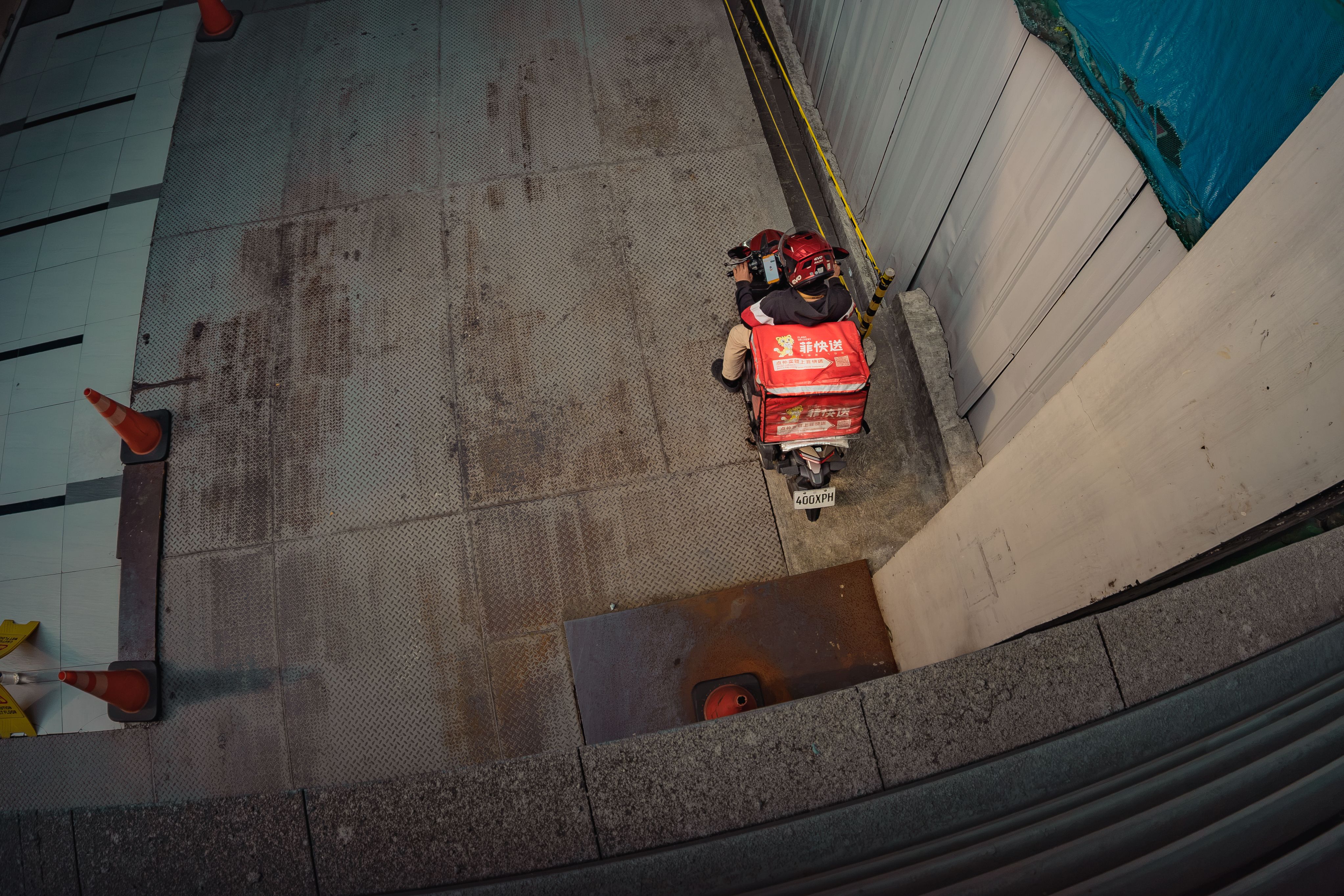 Aerial view of a delivery rider on a scooter navigating the streets of Pasig, Metro Manila.
