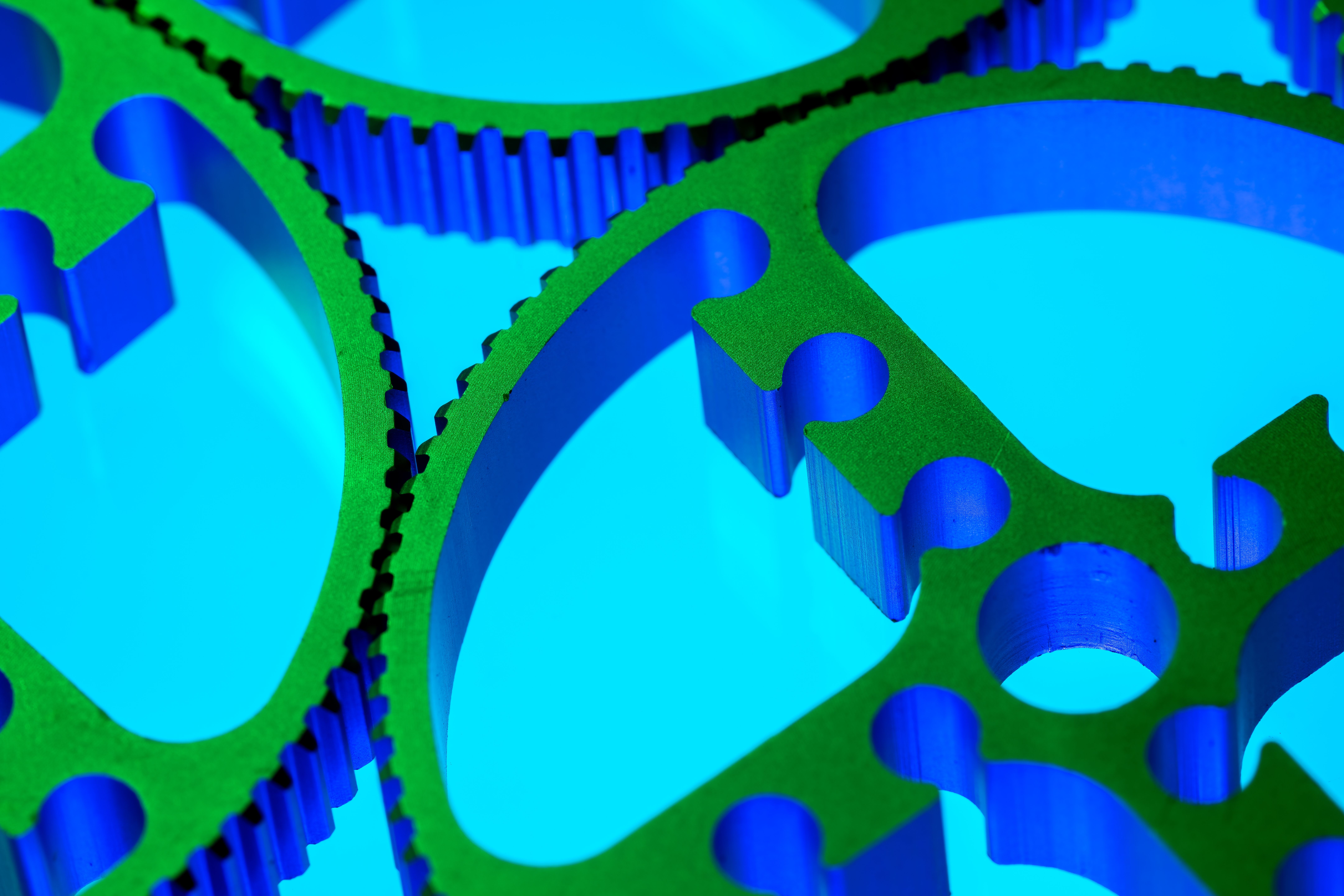 Colorful metallic gears under vibrant lighting.