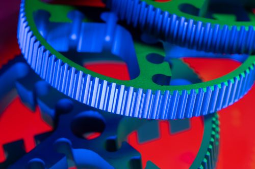 Free Vivid macro shot of colorful interlocking gears showcasing precision engineering. Stock Photo