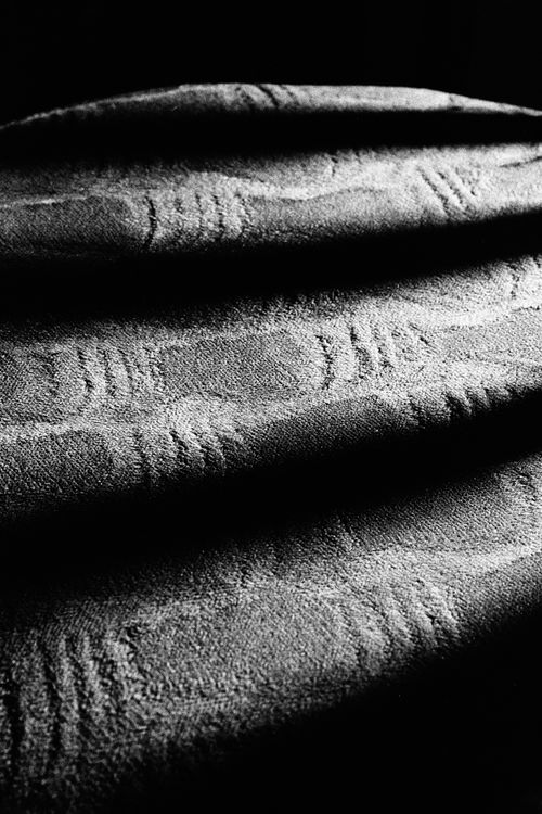 Free Monochrome image of intricate textured fabric patterns in dramatic light. Stock Photo