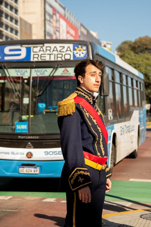 Free Portrait of a man in traditional uniform standing in front of a Buenos Aires city bus. Stock Photo