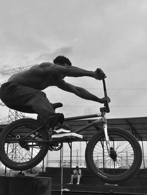 Free Black and white photo of a BMX rider performing a stunt in Lagos, Nigeria. Stock Photo
