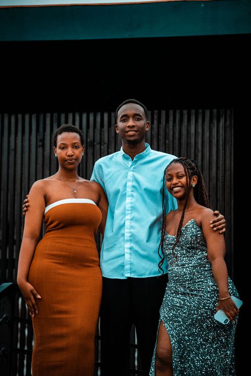 Free Three stylish young adults posing together outdoors in Rwanda, showcasing vibrant clothing. Stock Photo