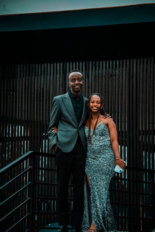 Free Stylish couple in formal attire posing on a staircase in Rwanda. Stock Photo
