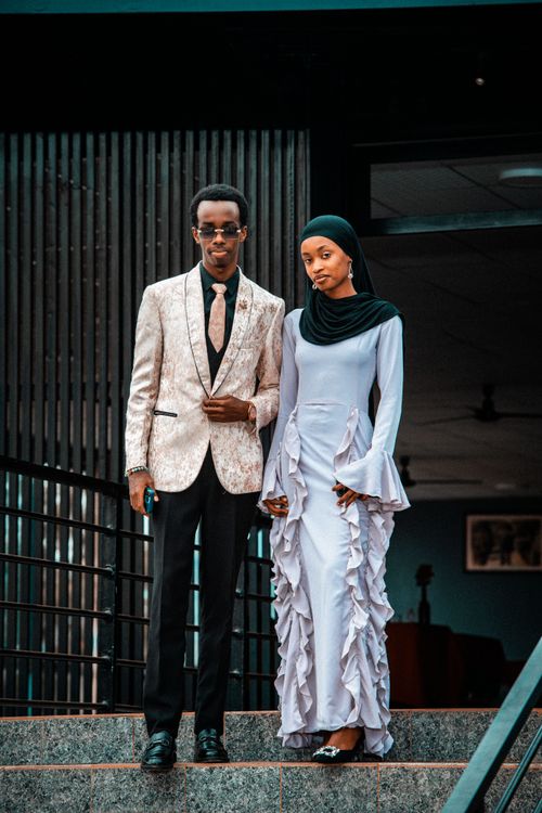 Free Stylish couple standing outdoors in formal attire, showcasing modern fashion in Rwanda. Stock Photo
