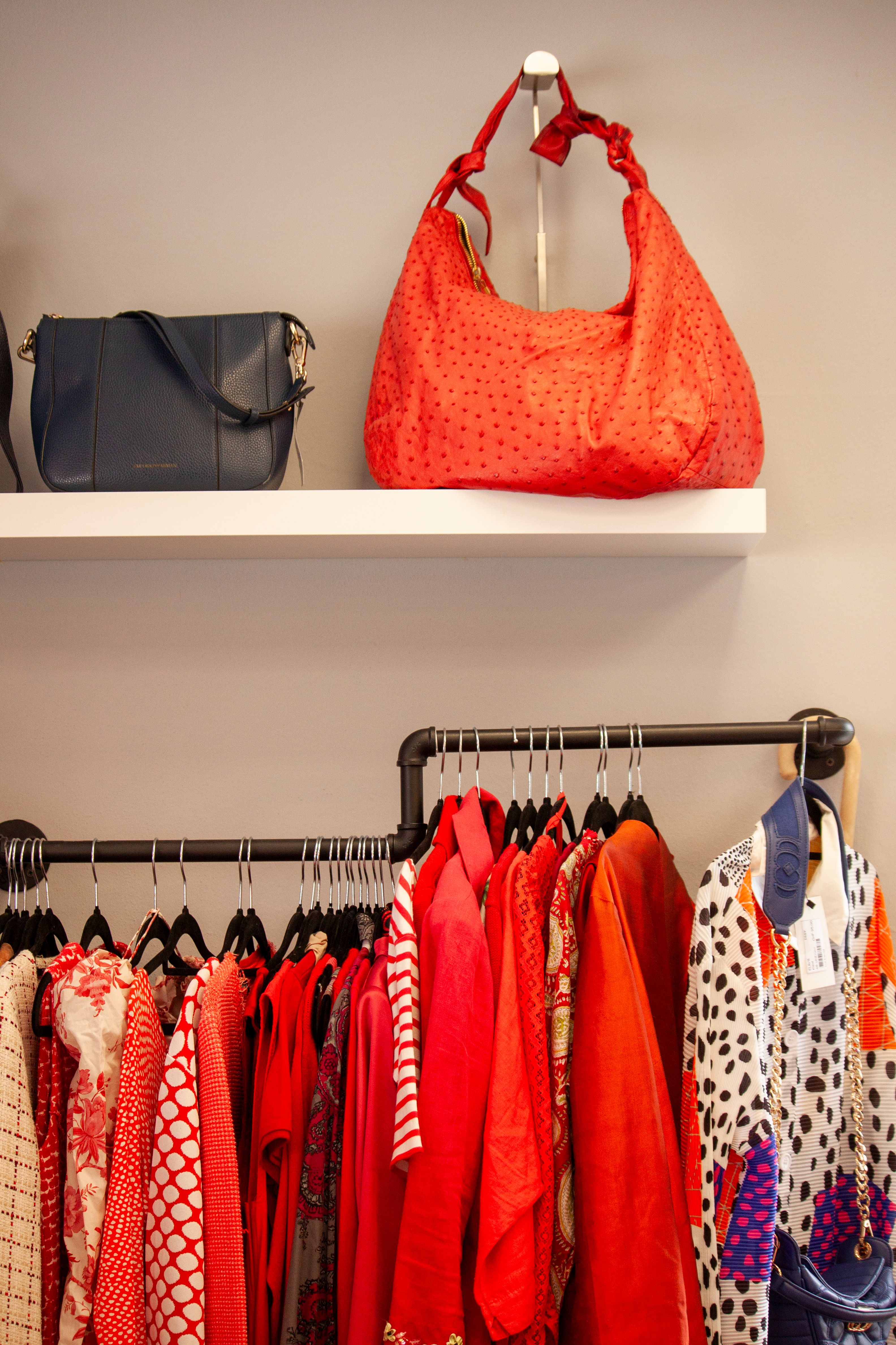 Vibrant red clothing and accessories displayed in a chic Lugano boutique, showcasing trendy fashion. - Seasonal Handbag Care Tips