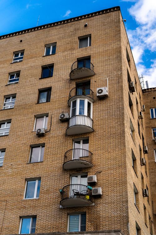 Free Modern brick apartment building in Moscow with small balconies and air conditioners. Stock Photo