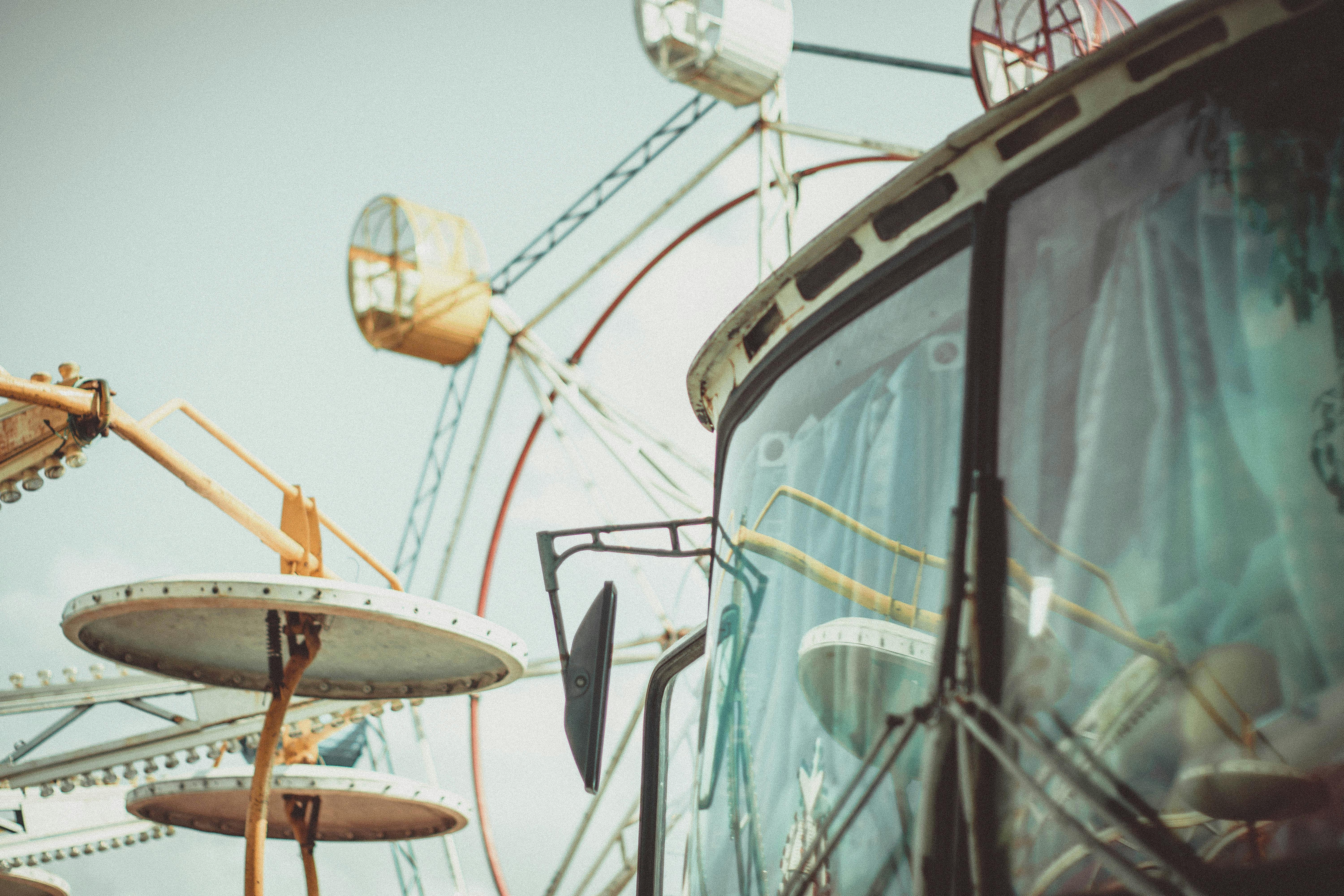 bus parked against ferris wheel